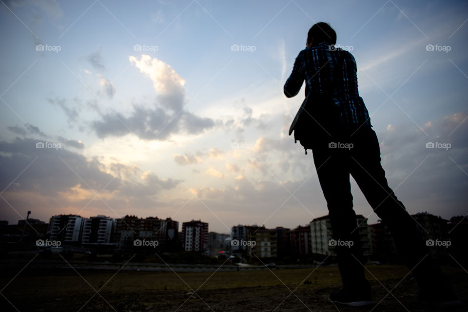 Male photographer standing rear view