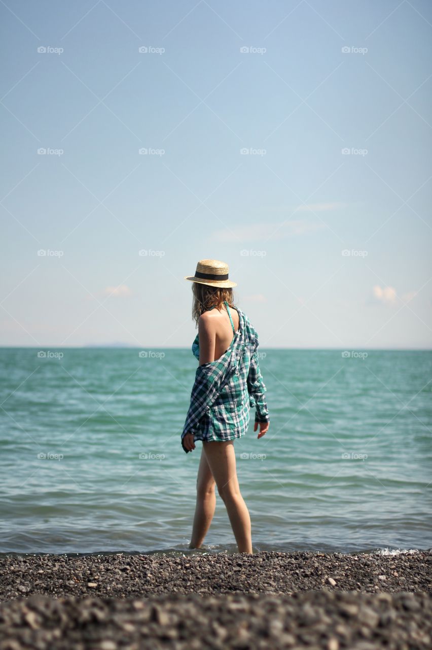 Girl walks along the beach