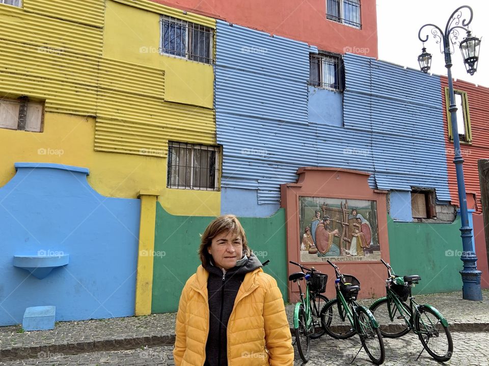 Woman in front of coloured palace 
