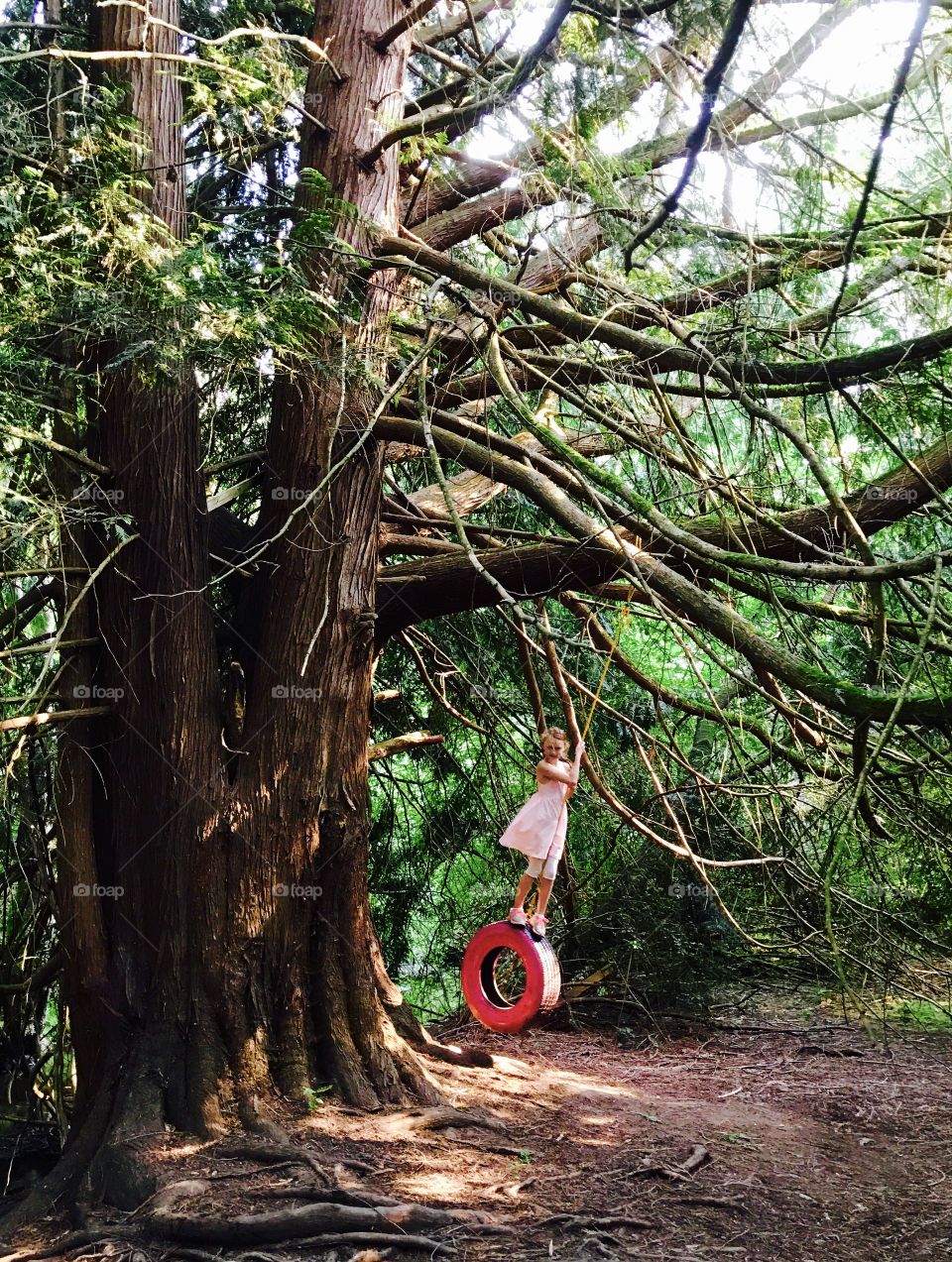 A tire swing made just for a girl - painted pink
