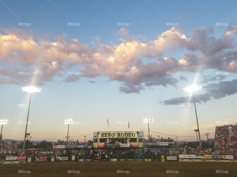 Reno rodeo grounds under a cotton candy colored sky and clouds