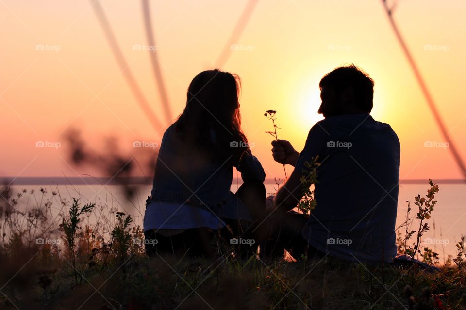 Silhouette of couple on the sunset 