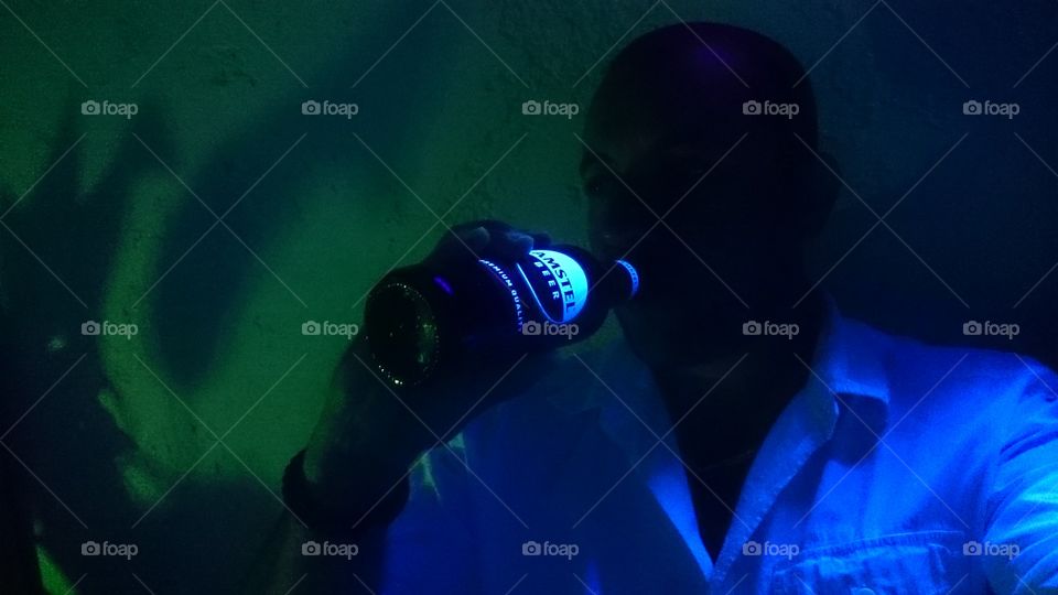 Under neon light, in the shadow, handsome man and a great beer...Nice