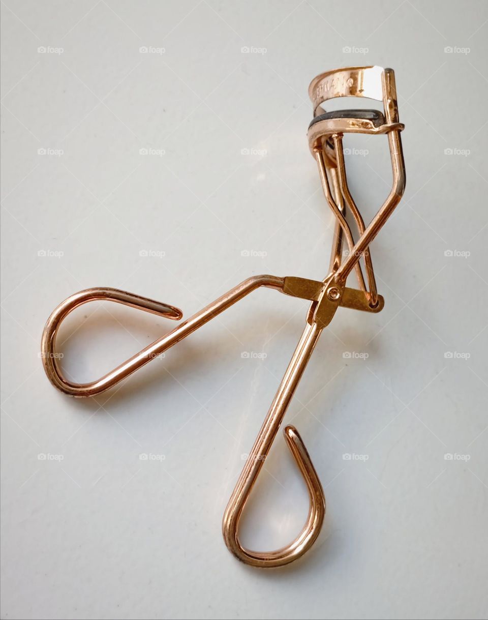 Eyelash curler in baby grey background...