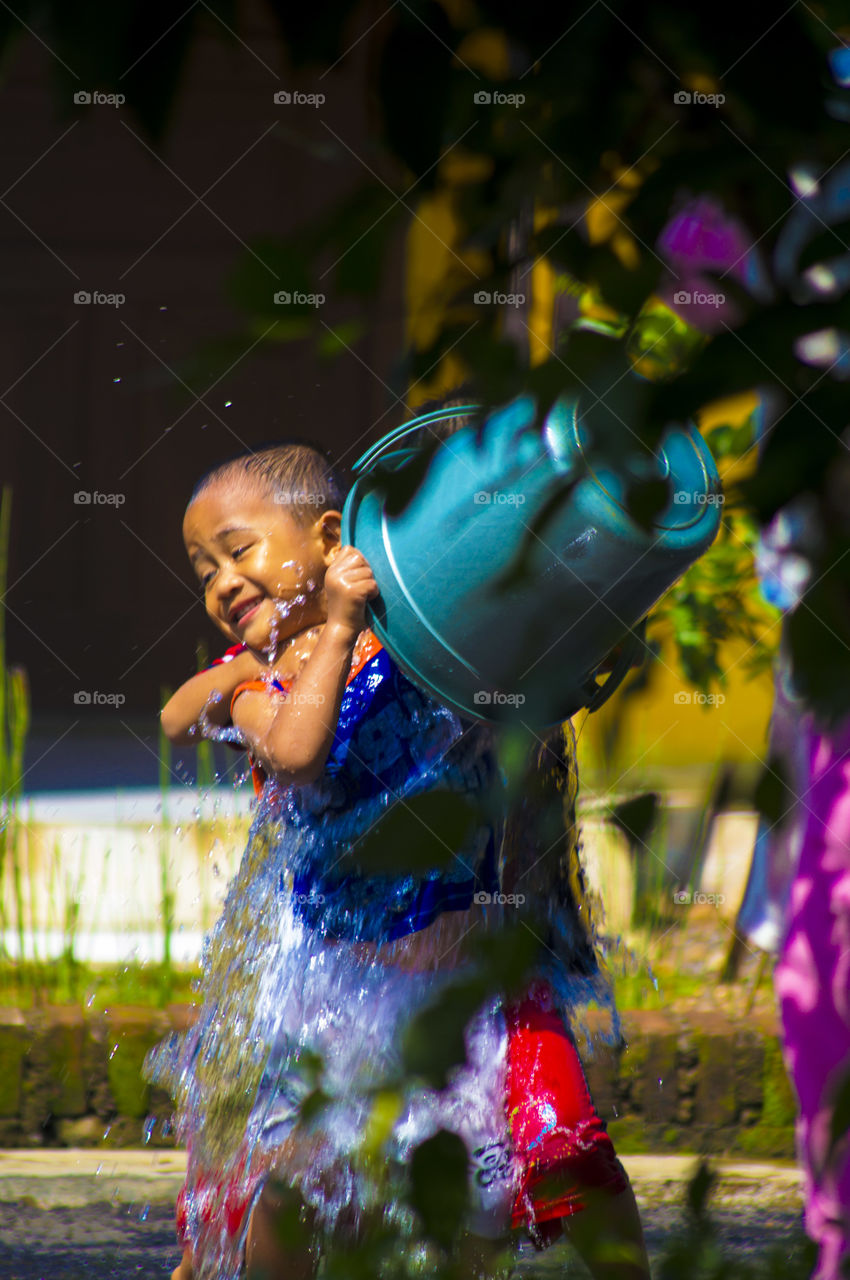 Boy pouring water his on body