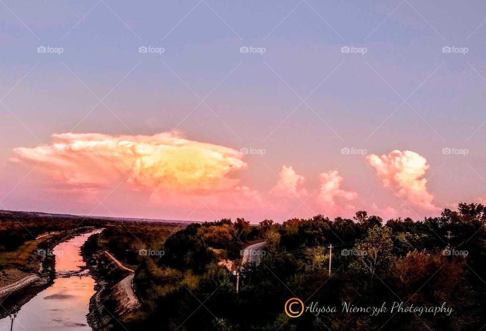 Goregous sunset over storm clouds by spillway outlet at lake, heading for town "Storm Clouds on the Move".