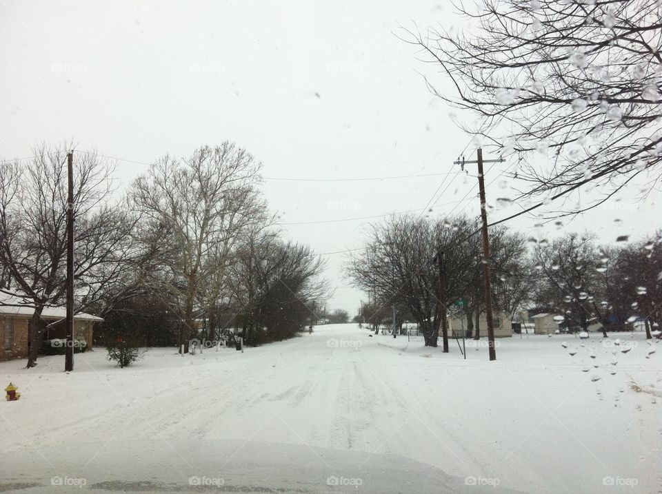 Snow covering the road in Sanger Texas. 