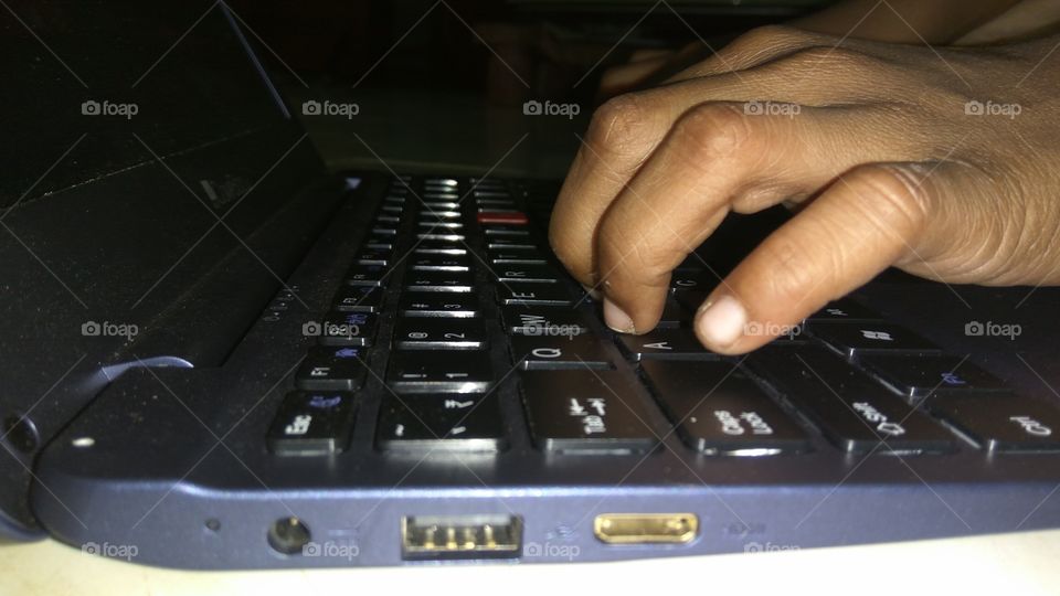 child operating  in laptop playing games