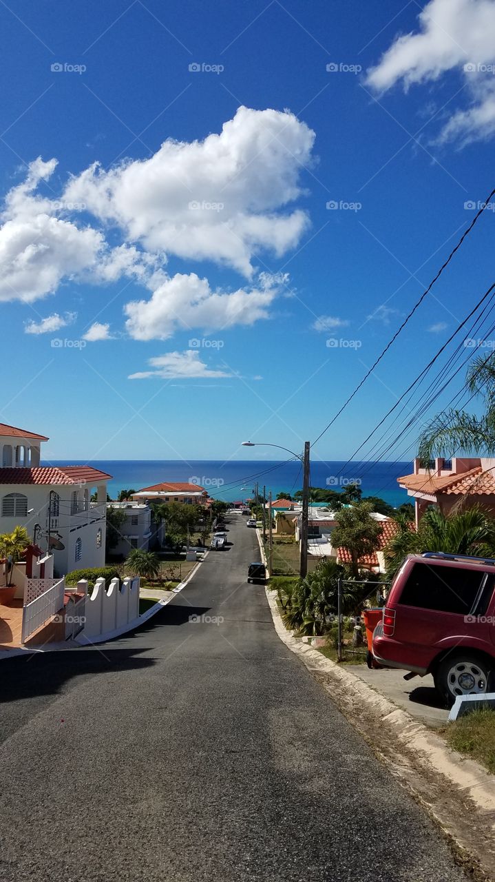 vertical view of a seaside road with ocean coastline in the background