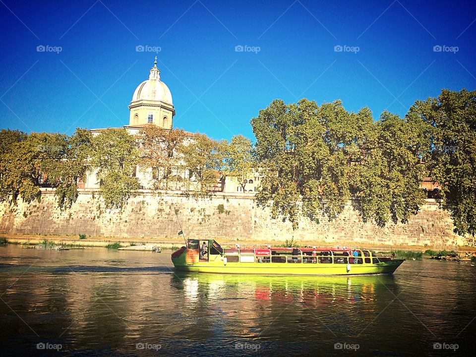 Boat on Tiber River in Rome Italy