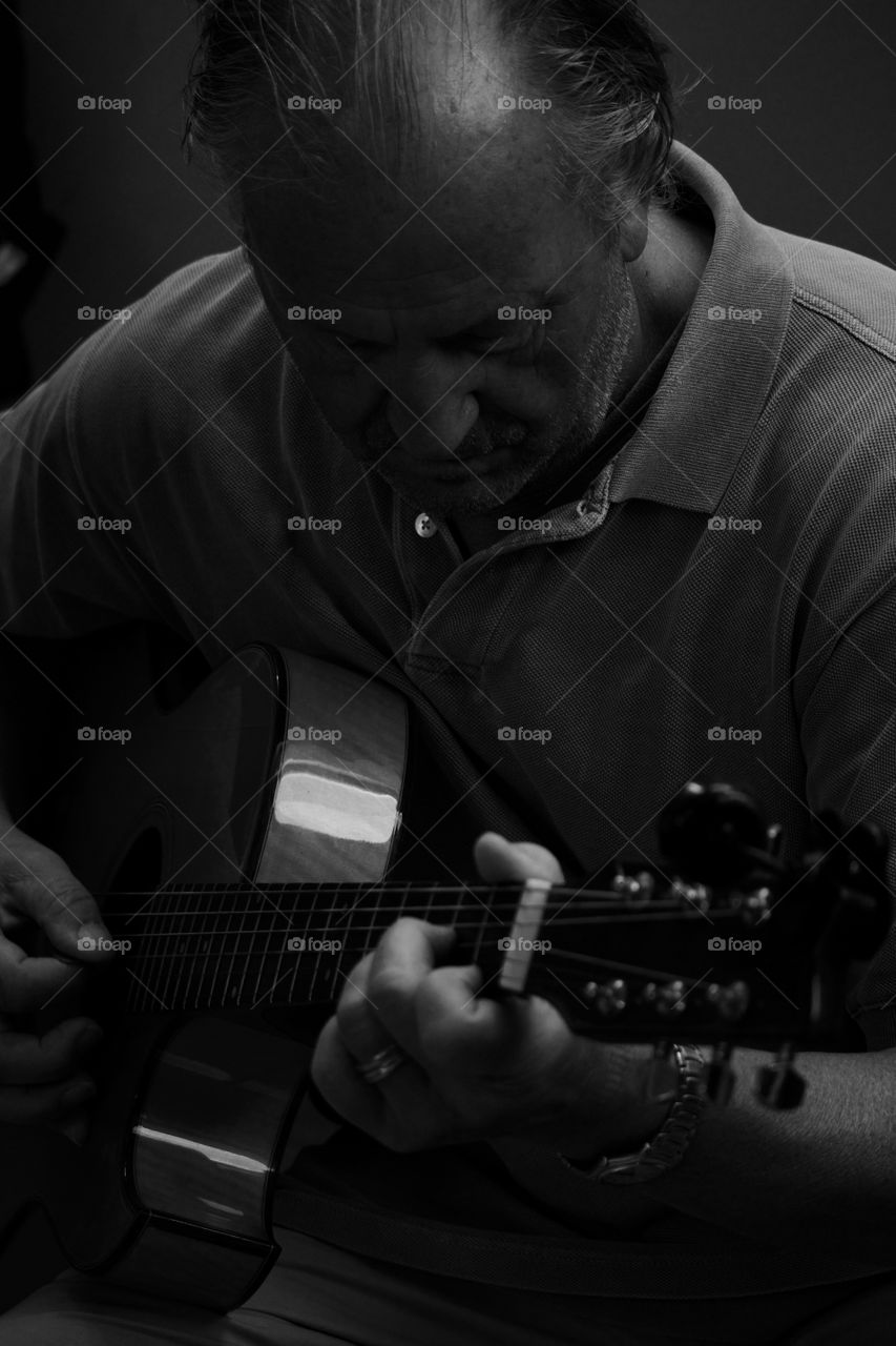 Portrait of man playing guitar