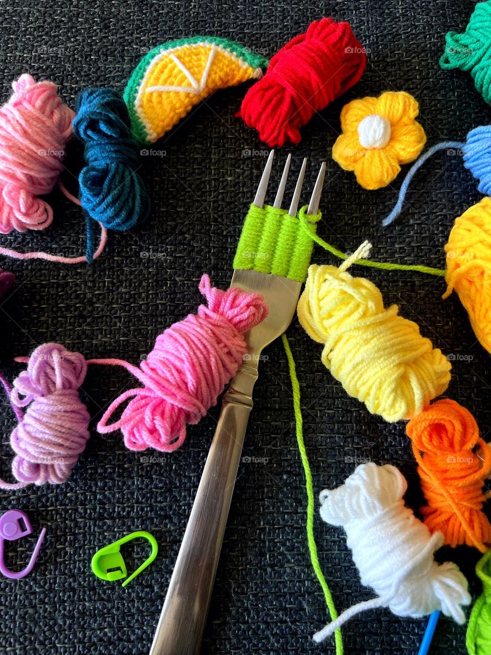 A fork with colorful woolen yarn.