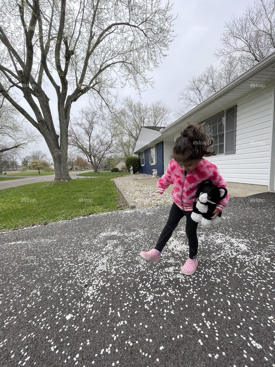 Toddler girl dancing in the petals from the tree, making memories with toddlers, springtime fun, dancing in the spring 