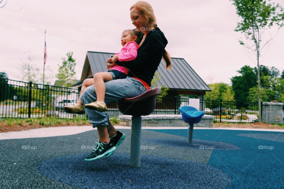 Daughter sitting on mother's lap