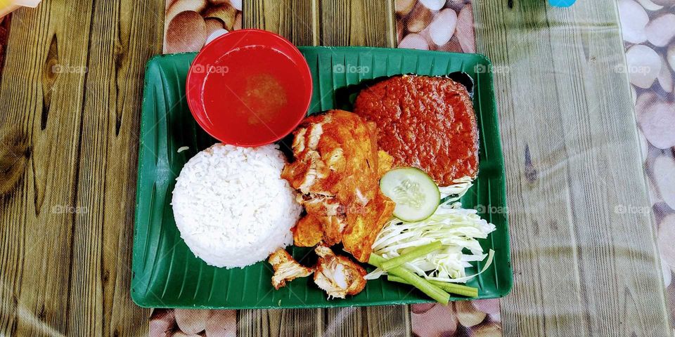 This food call ayam penyet. Its a indonesion food but also can be found in malaysia.