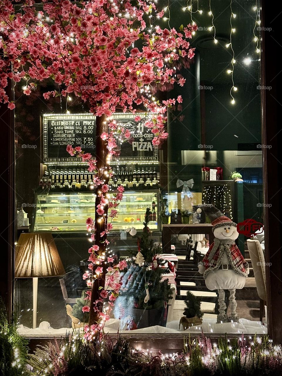 Cozy restaurant interior through the window, Christmas design 