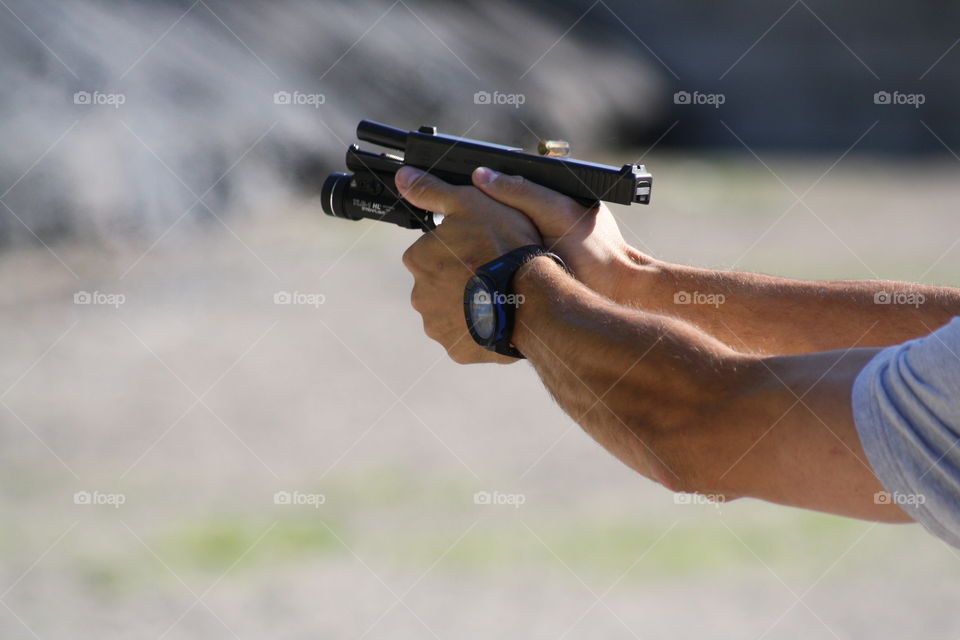 Shell casing landing on a Glock 17 9mm handgun during spring range training.