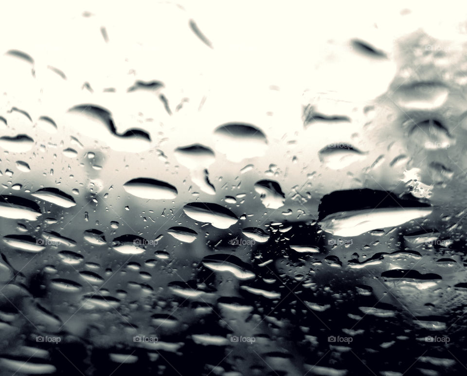 perfect rain drops on the glass of the car. abstract art, focus, black and white