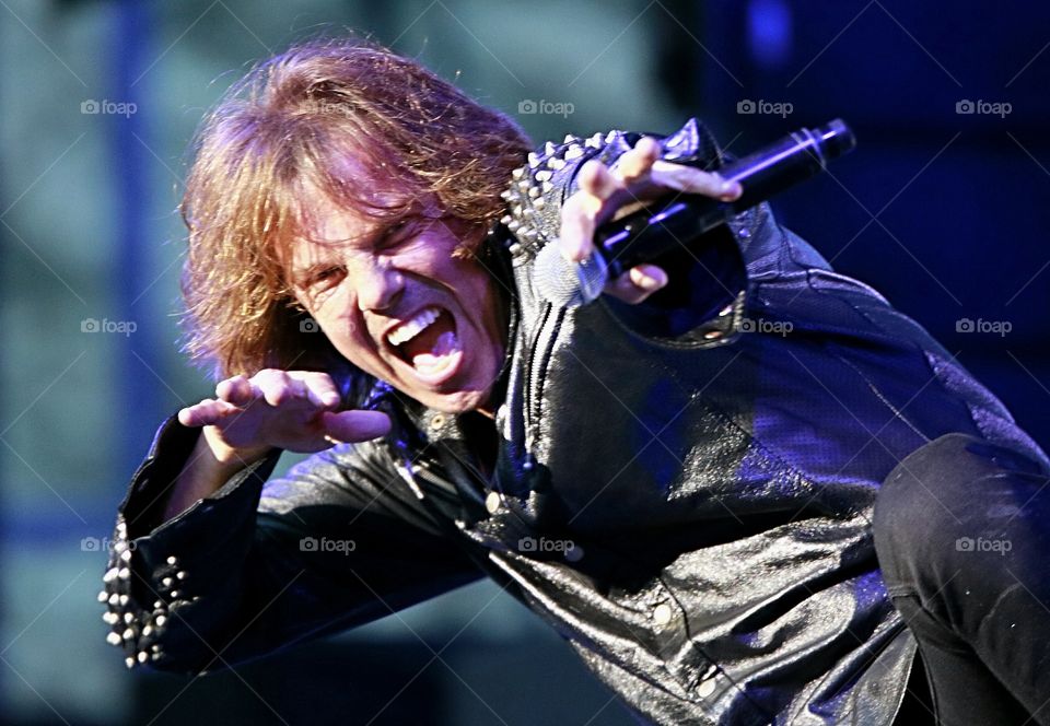 Portrait of male performer holding microphone