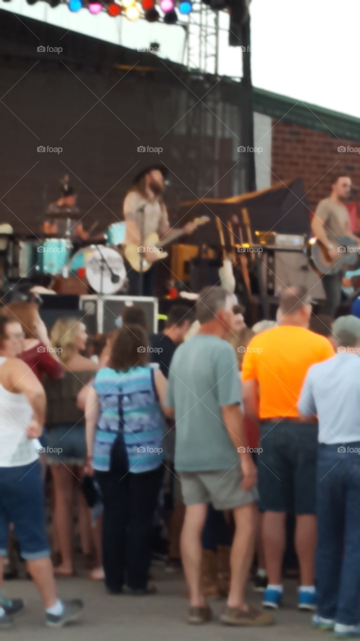 people standing and dancing  at a concert