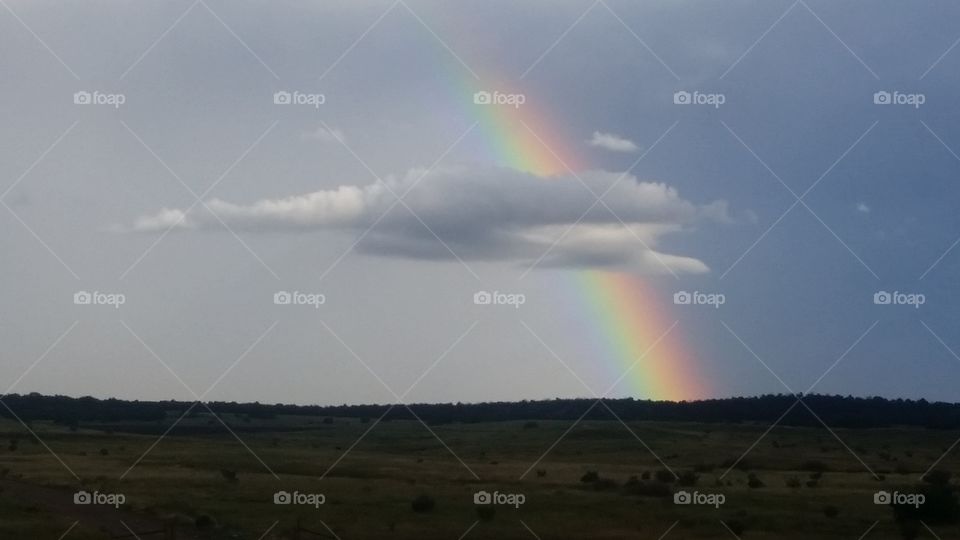Rainbow breaks out behind the clouds