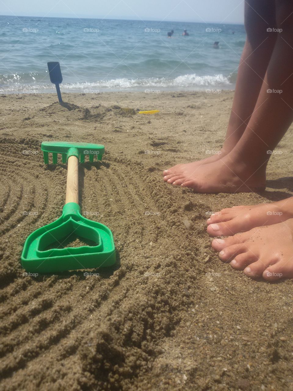 Kids legs on the beach in sand