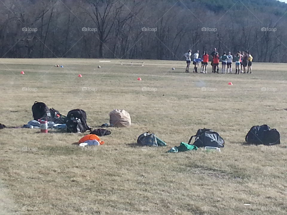 bags, gear and players. soccer practice