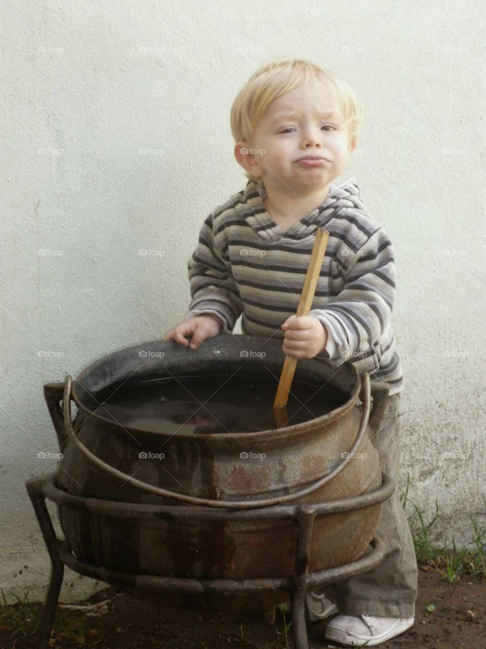 child stirring pot. playing like cooking