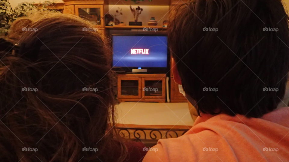 Young couple expectantly get ready to enjoy a Netflix movie night date