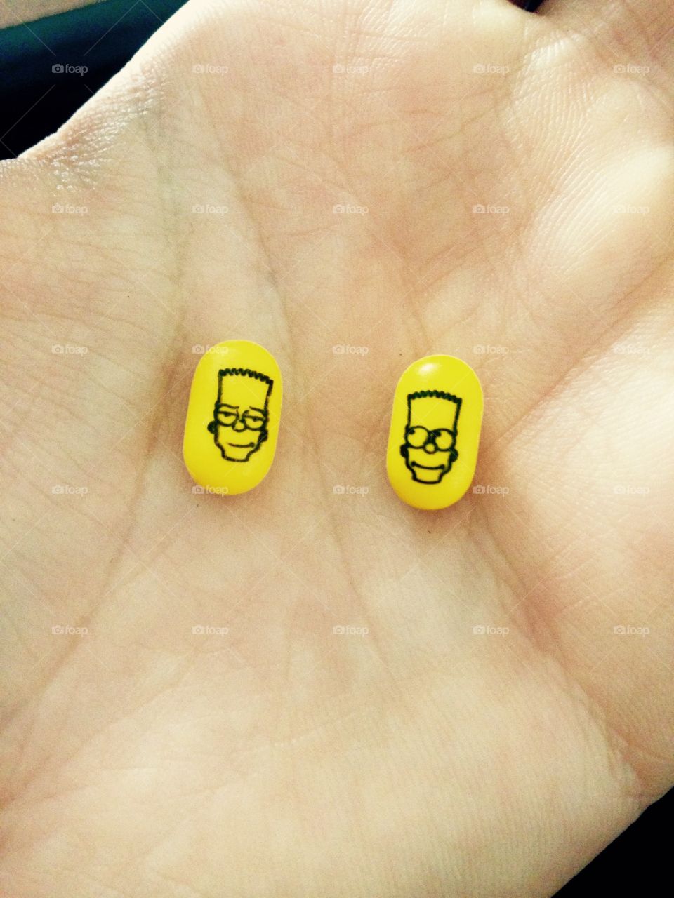 Happy and sad face of pills on palm off hand