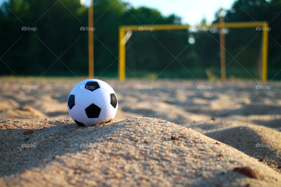 soccer ball and blurred goal in the background