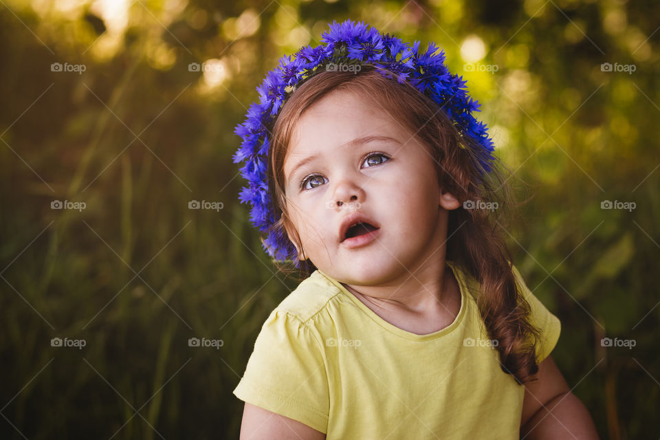Girl in wreath of flowers