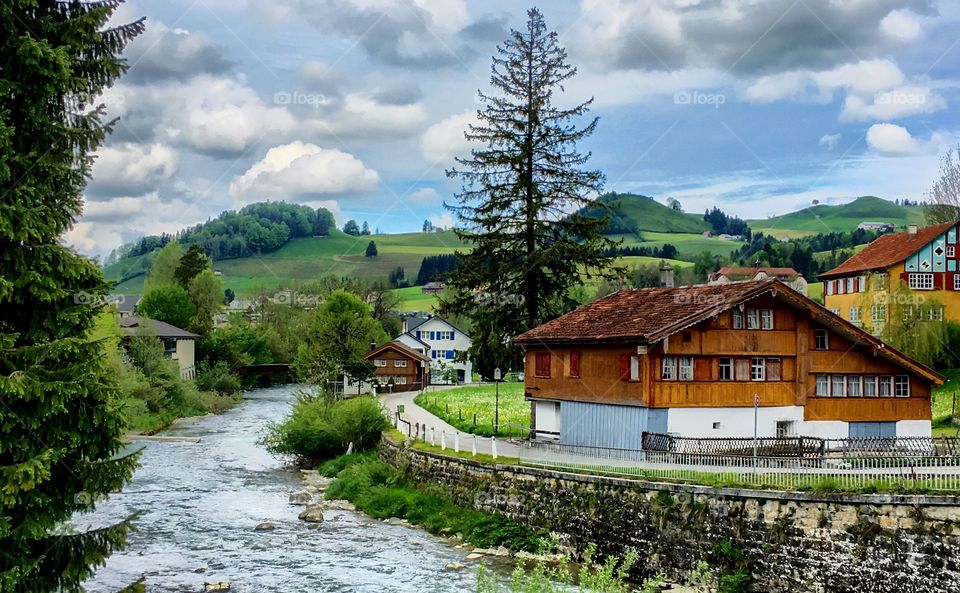 typical house on the sitter, the river which flows across the historical appenzell, switzerland.