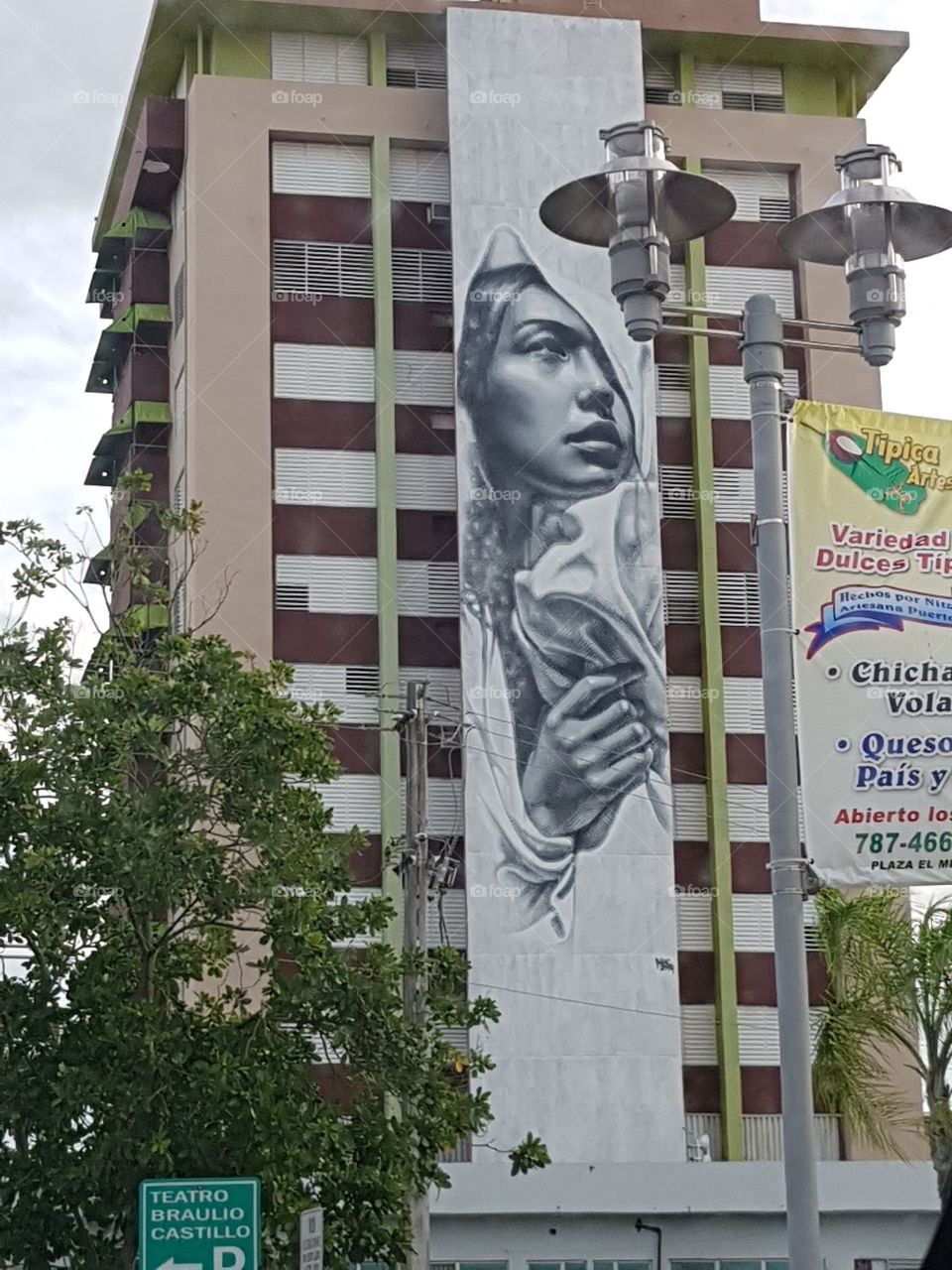 Woman Painting on Residencial Building