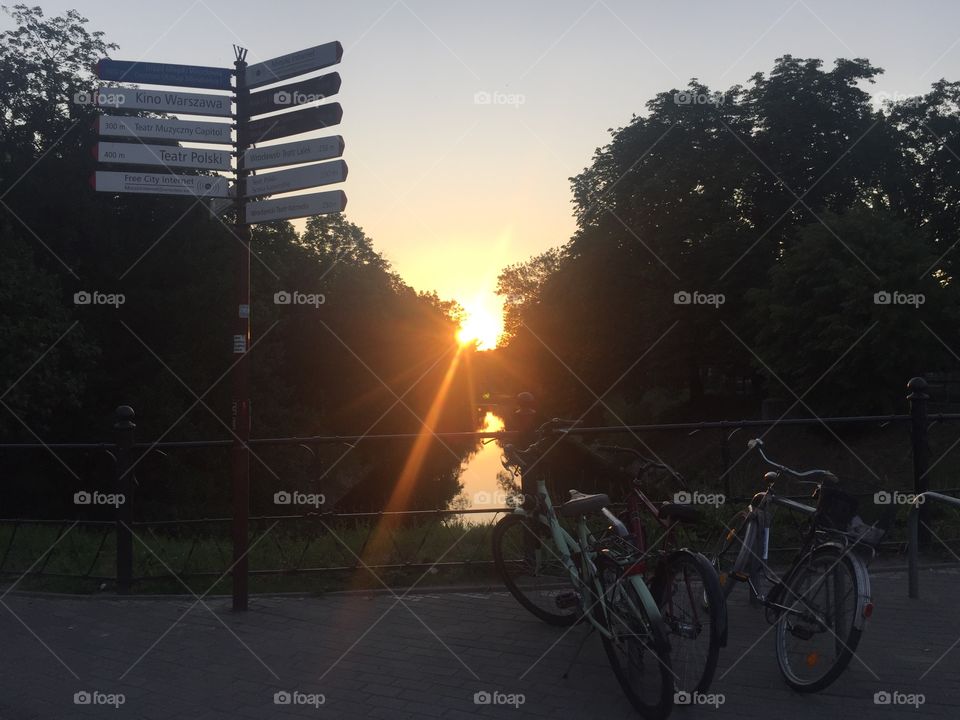 Bicycle parking on the river band in sunset