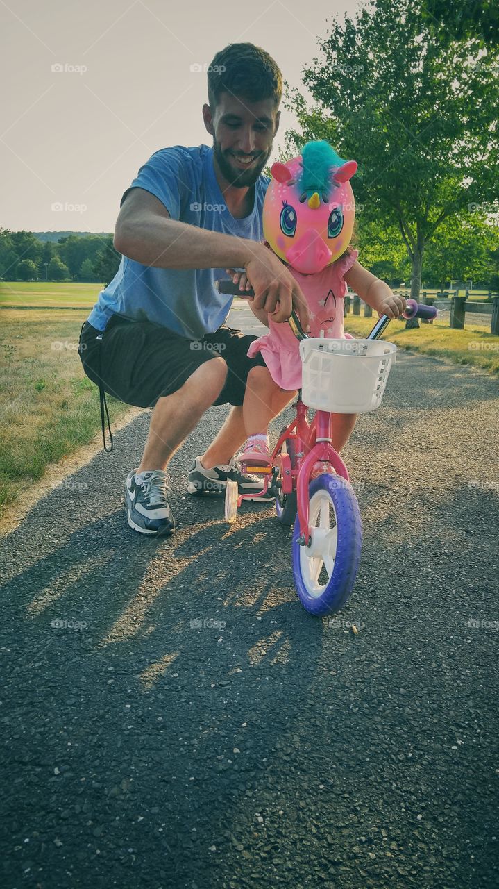 Father riding his daughter on bicycle