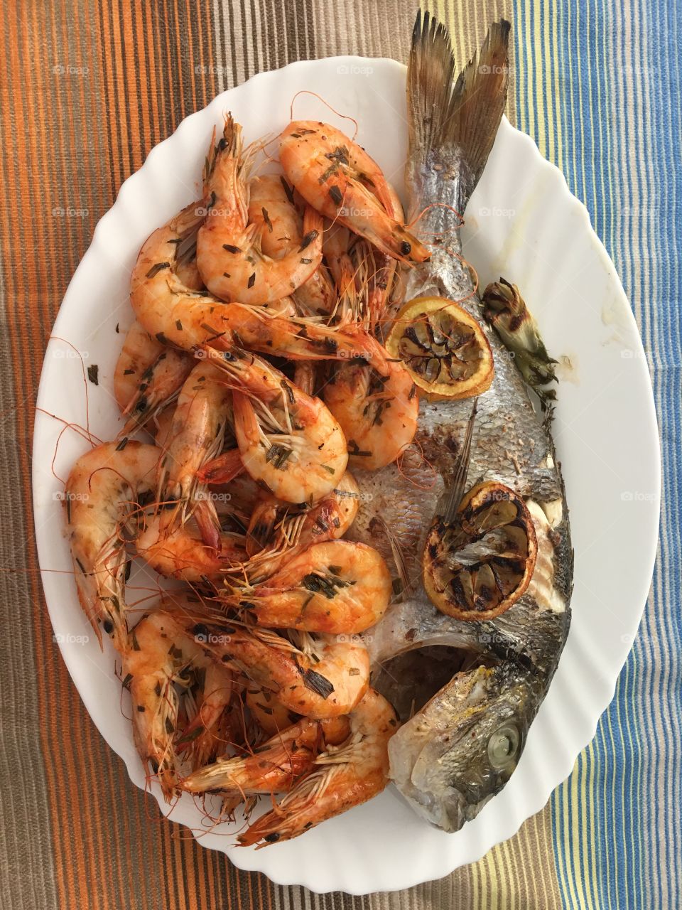 Home made shrimps with tarragon and tsipura fish with lemon