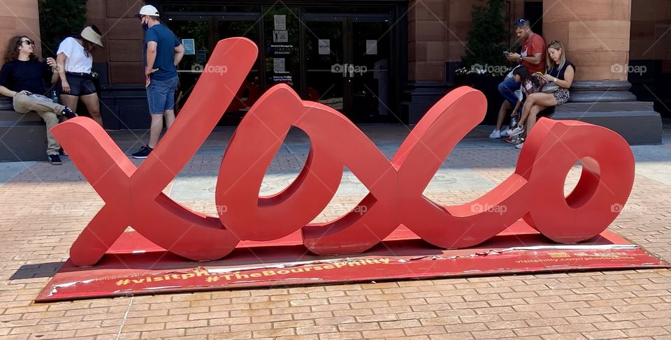 Metal Red letters XOXO making a sign for Philadelphia, the “City of Brotherly Love”, symbolizing hugs and kisses, sitting on brick pavement