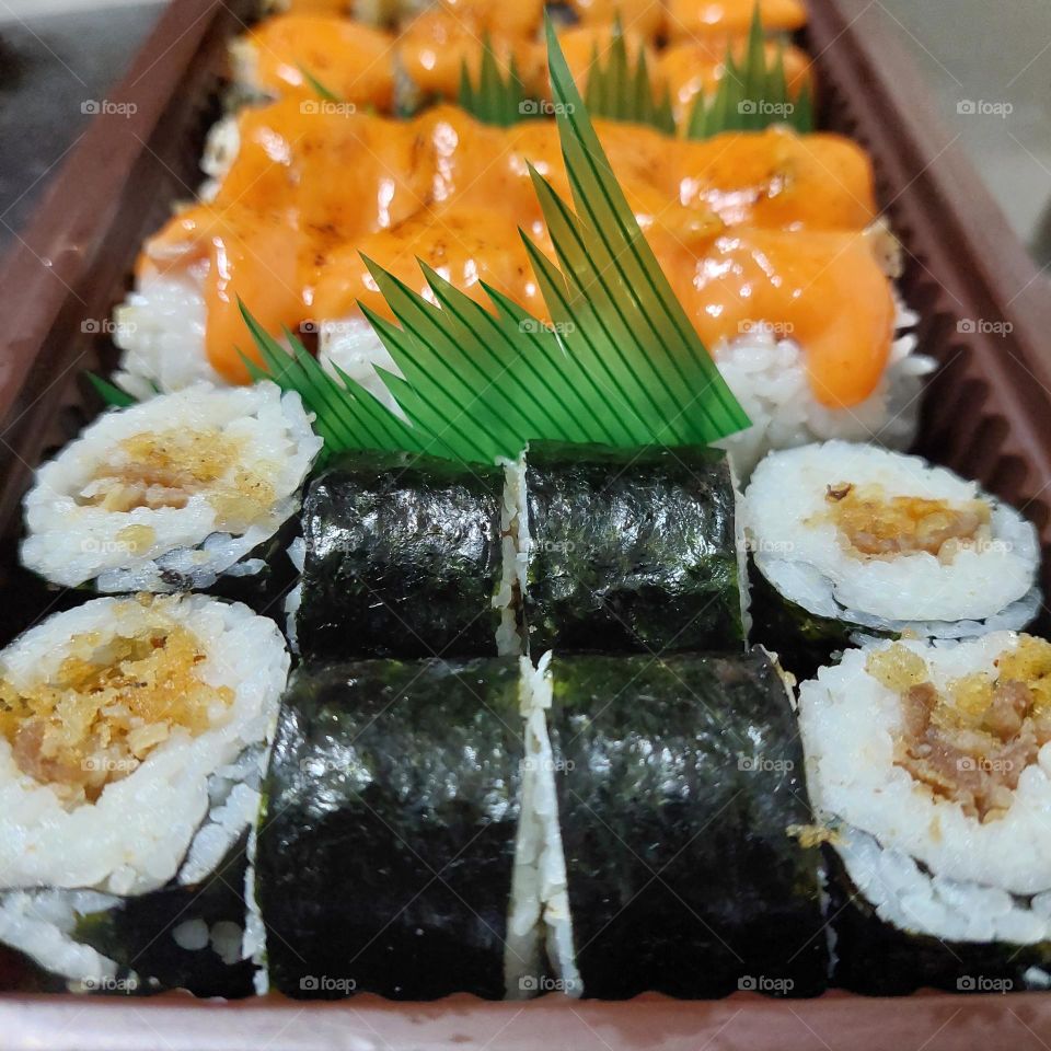 assorted sushi served in a container