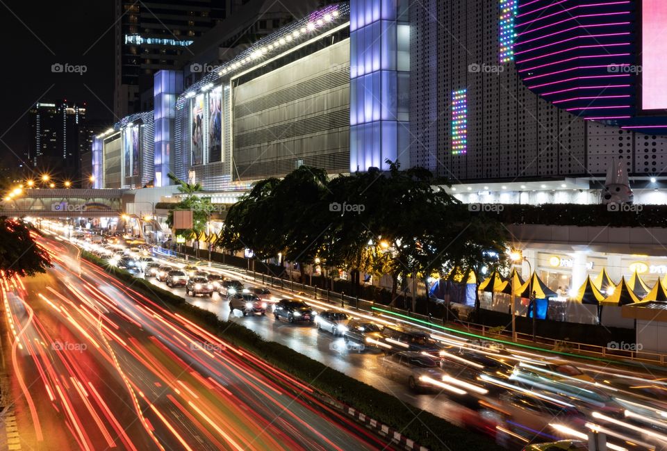 Beautiful light of Vehicle lamp in the raining day in front of MBK is the most famous shopping center in Bangkok Thailand