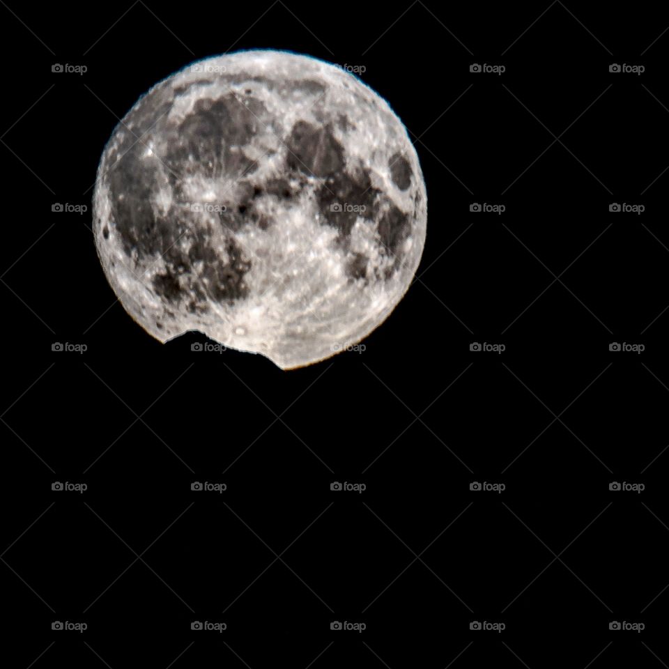 full moon rising over the mountain