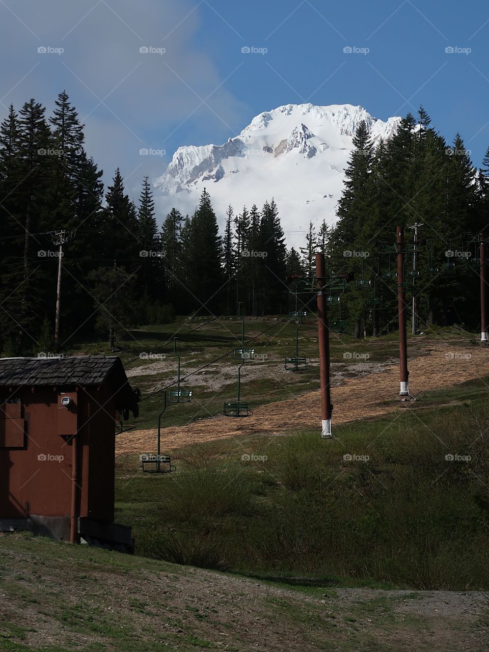 The magnificent Mt. Hood in Oregon’s Cascade Mountain Range covered in fresh springtime snow on a beautiful sunny day. 
