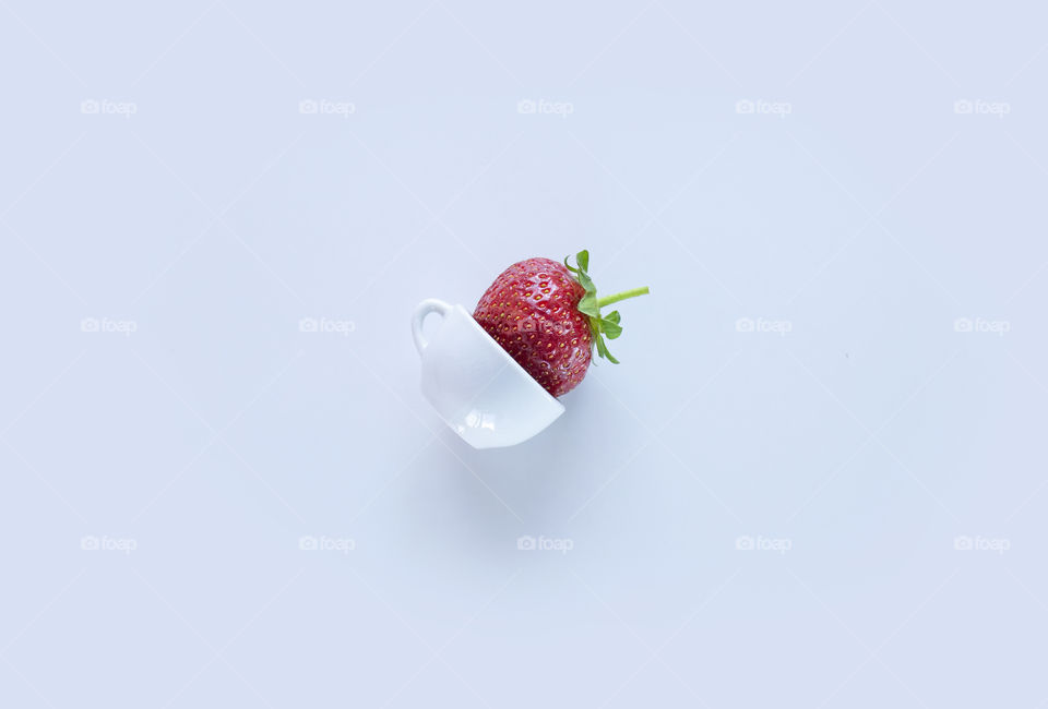 Strawberry on white background. Strawberry in tiny cup 