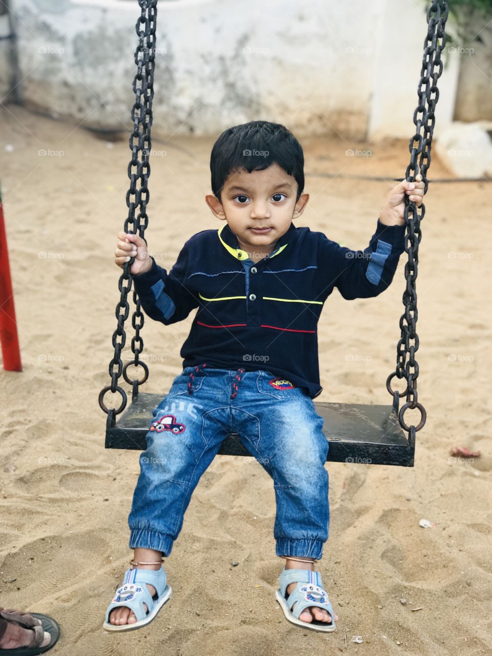 Indian baby boy swinging on swing