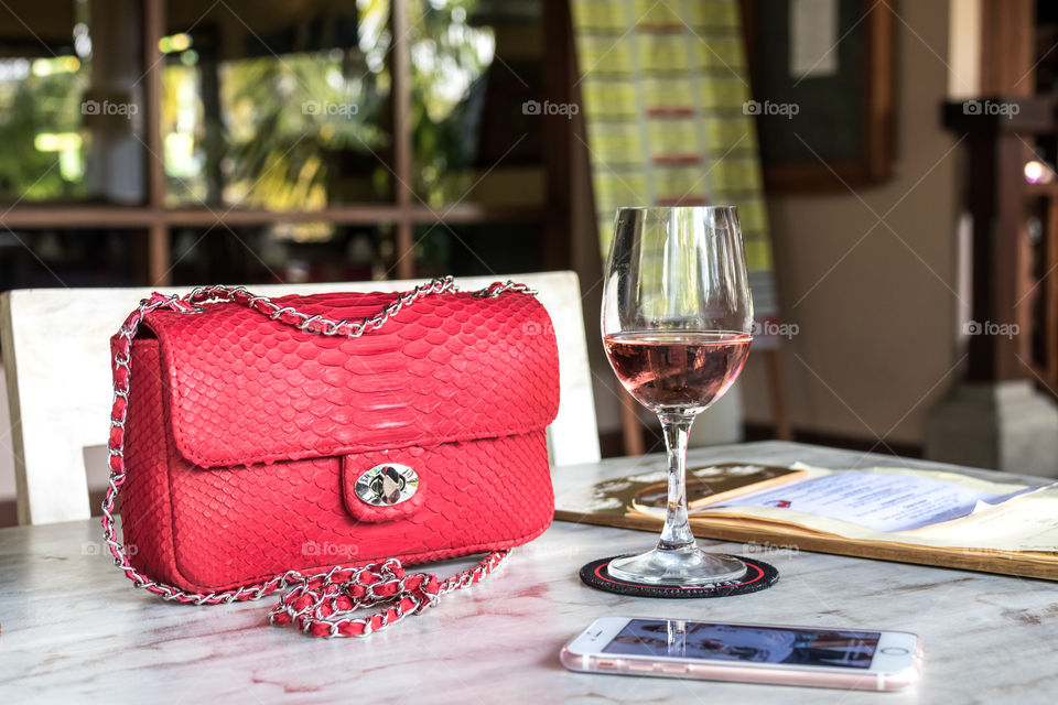 Red python bag on the table