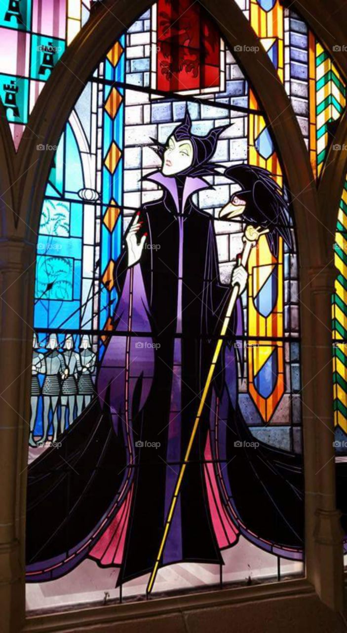 maleficent window
Disney land Paris / Euro Disneys
one of Sleeping beauty castles
stain glass window
(series available )
Maleficent (/məˈlɛfɪsənt/ or /məˈlɪfɪsənt/) is the main antagonist of Walt Disney's 1959 film Sleeping Beauty. She is characterized as the "Mistress of All Evil" who, after not being invited to a christening, curses the infant Princess Aurora to "prick her finger on the spindle of a spinning wheel and die" before the sun sets on Aurora's sixteenth birthday.
Sleeping Beauty Castle is the fairy tale structure castle at the center of Disneyland Park, Hong Kong Disneyland and Disneyland Paris. It is based on the late-19th century Neuschwanstein Castle in Bavaria, Germany,with some French inspirations (especially Notre Dame de Paris and the Hospices de Beaune).