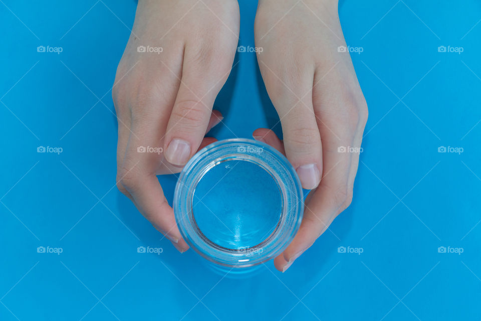 a glass of water in hands