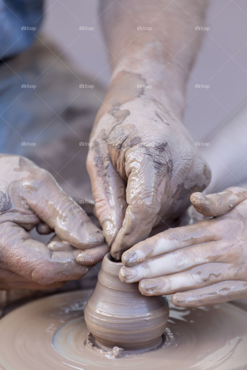 Close-up of a hand making pottery