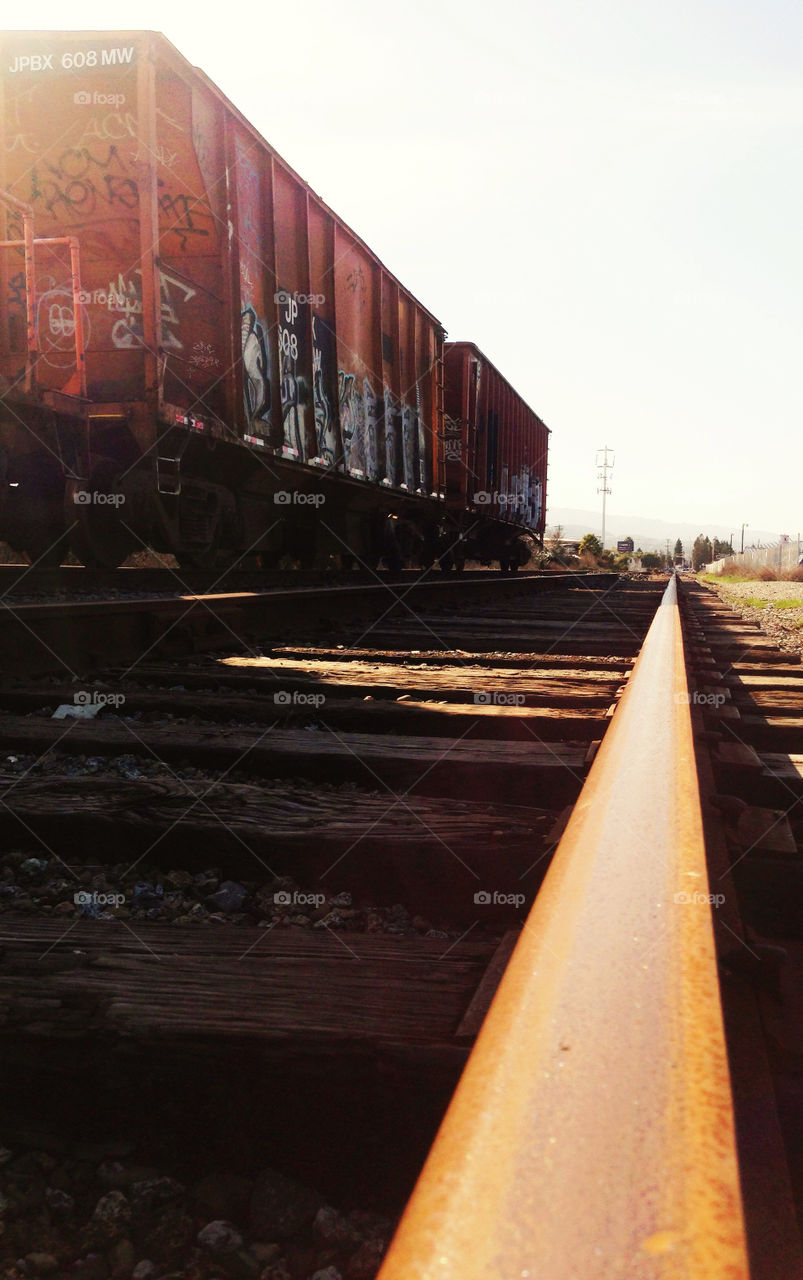 Rolling boxcars of a freight train and steel track