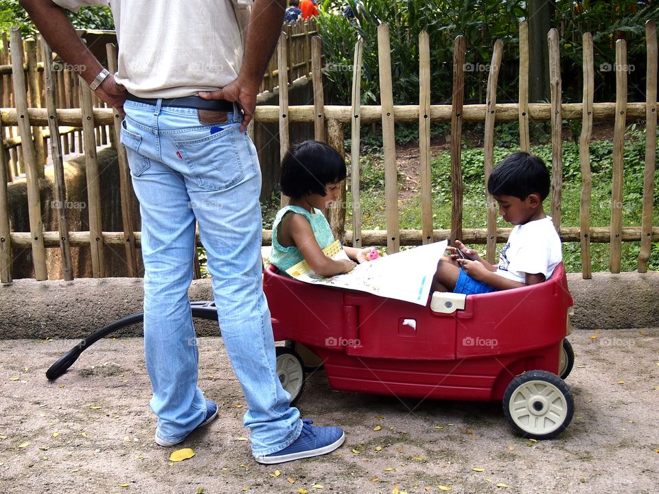 two kids riding a cart